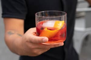 Hand holding a Negroni