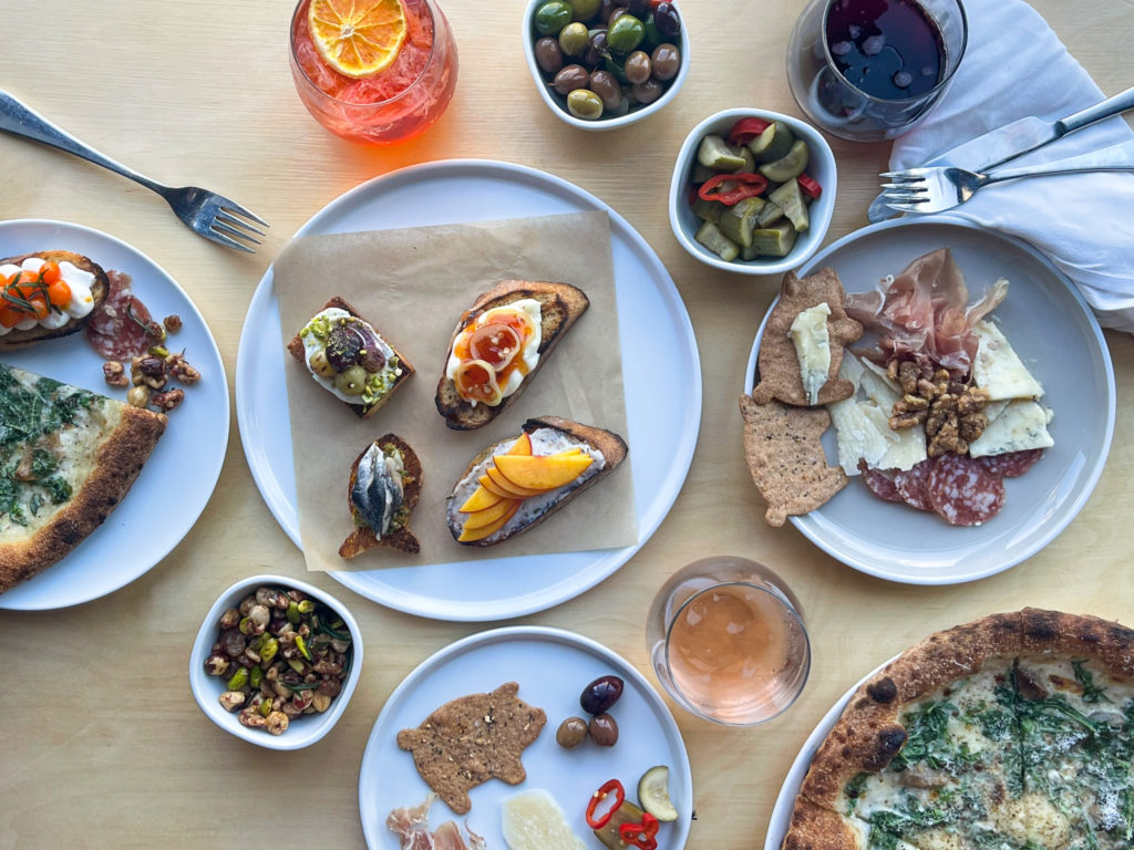 Variety of snacks, cocktails, wine and pizza