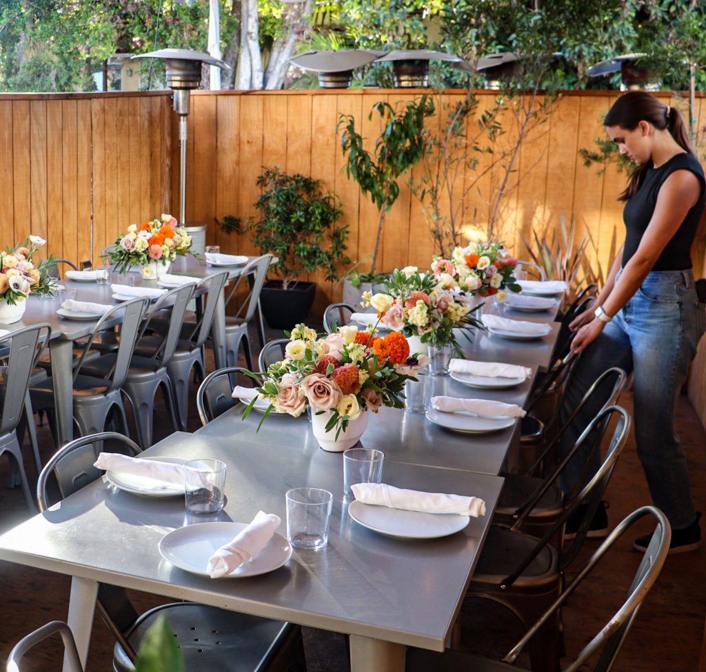 woman setting up table for an event